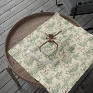 Woodland Deer and Pine Christmas wrapping paper spread flat with a wrapped gift and brown bow