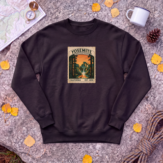 Black Yosemite National Park sweatshirt with vintage Half Dome stamp, flat-lay on granite with trail map and compass