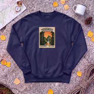 Navy Yosemite National Park sweatshirt with vintage Half Dome stamp, flat-lay on granite with trail map and compass