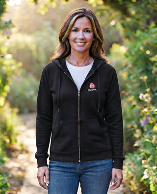 Woman wearing the black Breast Cancer Champion full-zip hoodie with pink boxing gloves and Champion script on the chest