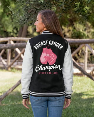 Back of the Breast Cancer Champion varsity jacket on a woman, with pink boxing gloves and Fight for Life lettering