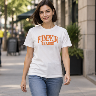 Woman wearing white Pumpkin Season varsity t-shirt with orange lettering
