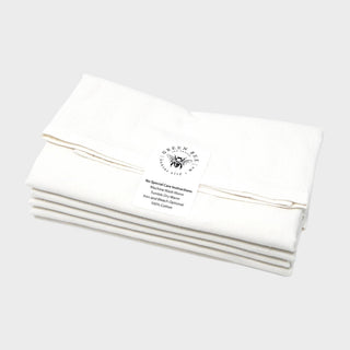 Folded 100% cotton Green Bee tea towels showing the brand and care label