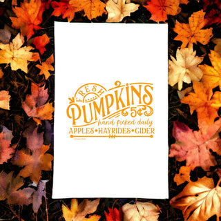 Fresh Pumpkin cotton tea towel displayed in a cozy fall kitchen