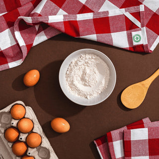 Red plaid cotton kitchen towels styled with baking ingredients
