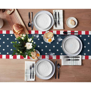 Dining table set with plates, cutlery, and a decorative American flag table runner.