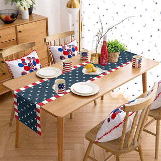Dining room with a table covered by an American flag-themed tablecloth, chairs with matching cushions, and decorative elements.